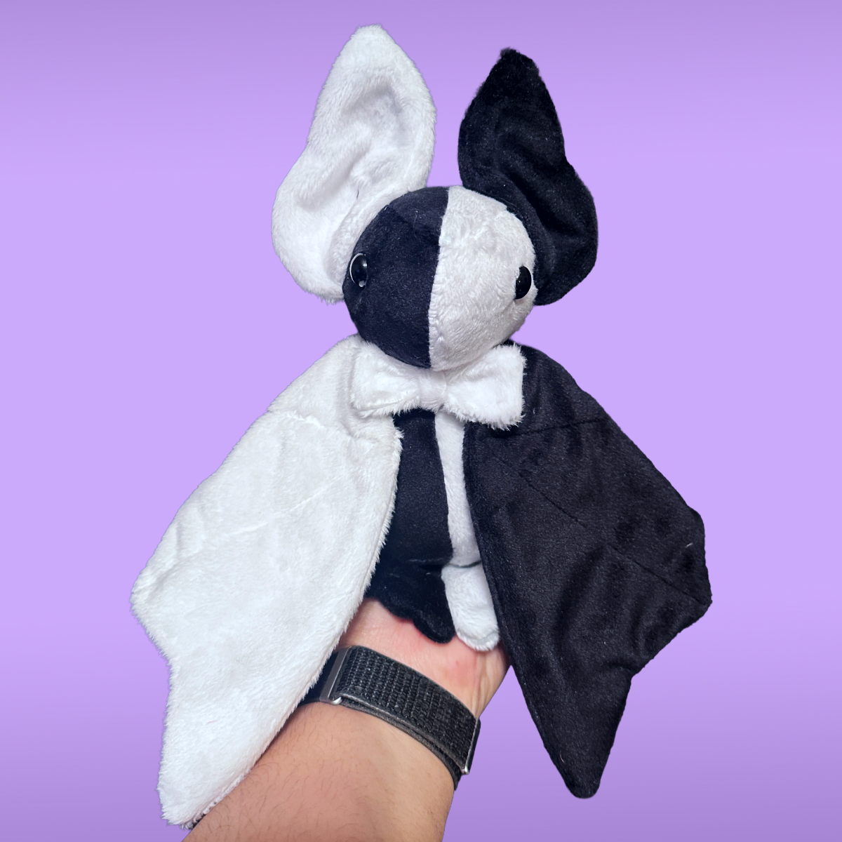 Plush toy resembling a bat made of minky fabric on a purple background