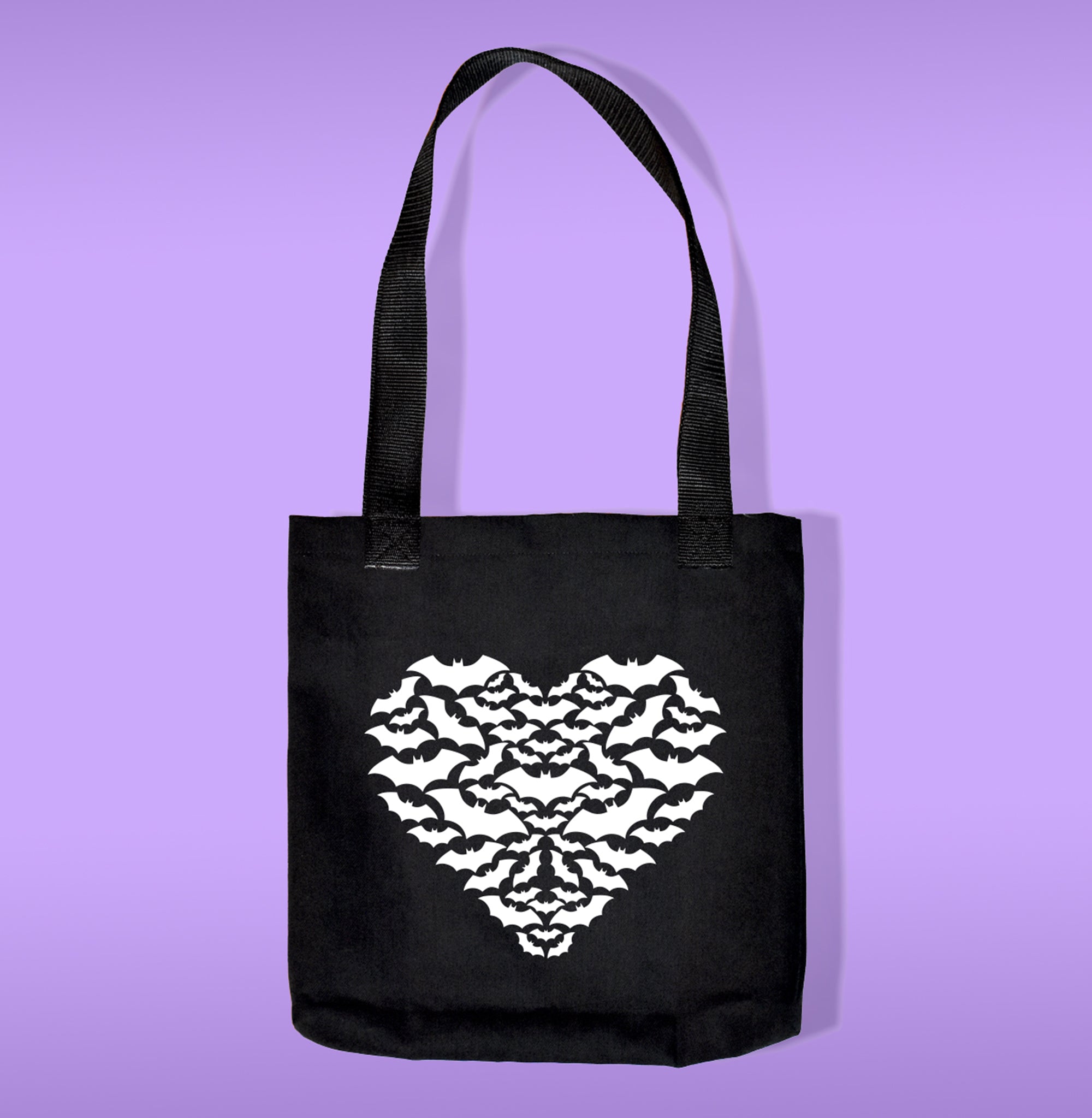 White bats shaped as a heart heat transfer on a black tote bag