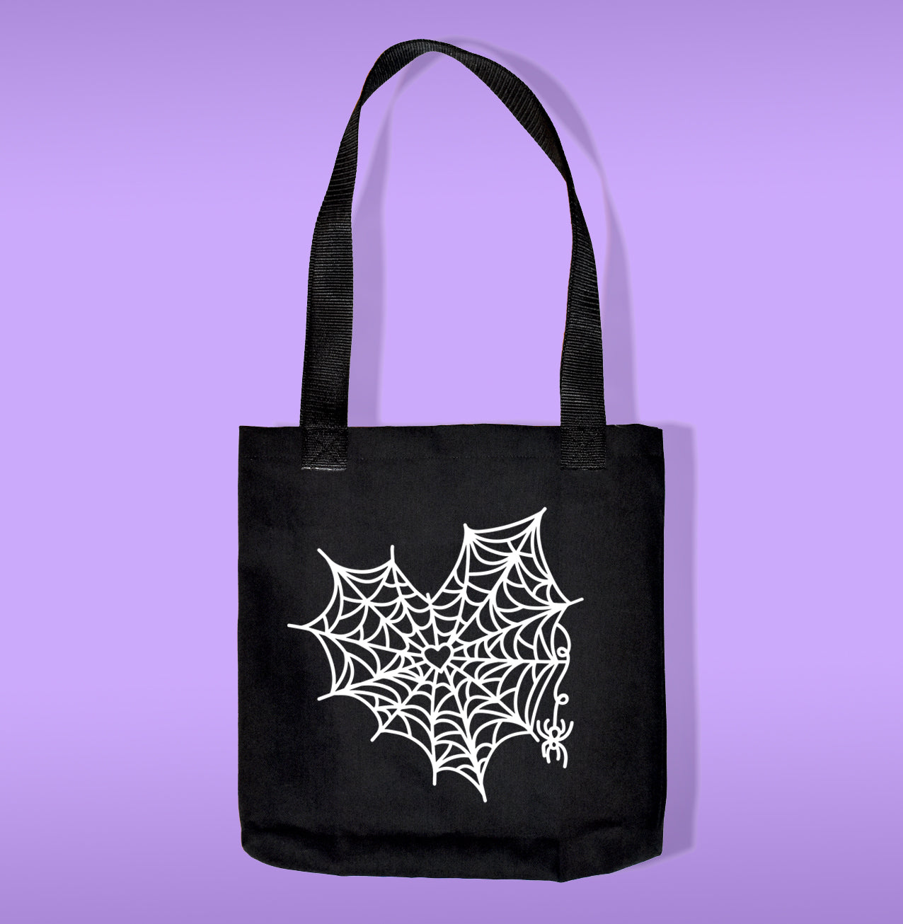 White heart spider web heat transfer on a black canvas tote