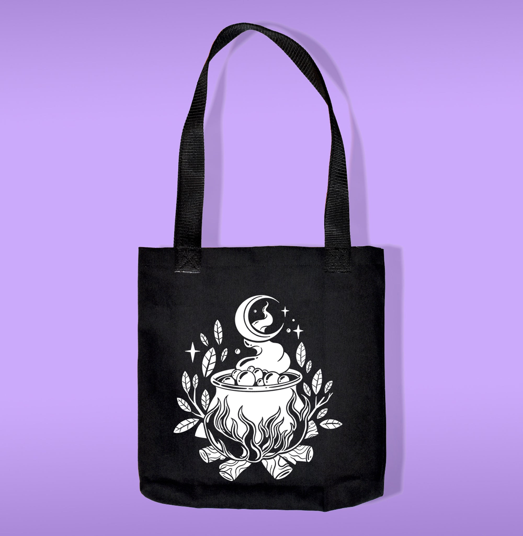 A black canvas bag with polypropelene straps. Features a caldron on fire heat transfer print
